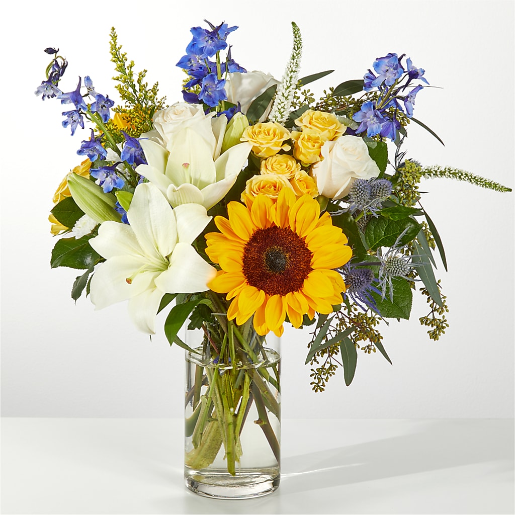 white lilies and sunflowers Wonderfully Sunny Winter Bouquet – blue, white, yellow flower arrangement | Kokomo, IN